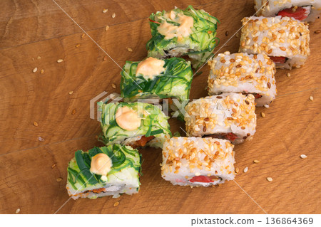 Sushi rolls on a wooden board delicious food Sushi rolls on a wooden board delicious food 136864369