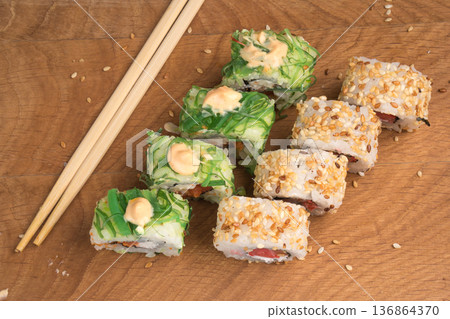Sushi rolls on a wooden board delicious food 136864370
