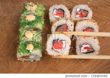 Sushi rolls on a wooden board delicious food Sushi rolls on a wooden board delicious food 136864380