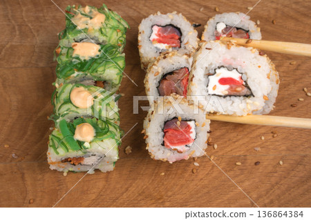 Sushi rolls on a wooden board delicious food Sushi rolls on a wooden board delicious food 136864384