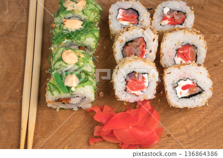 Sushi rolls on a wooden board delicious food Sushi rolls on a wooden board delicious food 136864386
