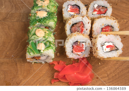 Sushi rolls on a wooden board delicious food Sushi rolls on a wooden board delicious food 136864389