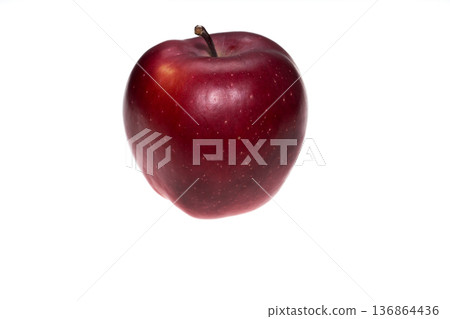 one apple of dark red color on a white background in isolation 136864436
