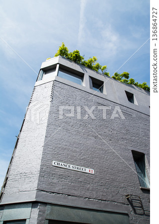 A streetscape of brick and modern buildings under bright sunlight in Shoreditch, East London A streetscape of brick and modern buildings under bright sunlight in Shoreditch, East London 136864727