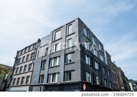 A streetscape of brick and modern buildings under bright sunlight in Shoreditch, East London 136864729