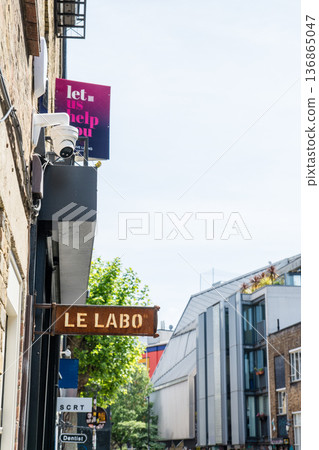 English sign attached to a brick building under bright sunlight in Shoreditch, East London 136865047