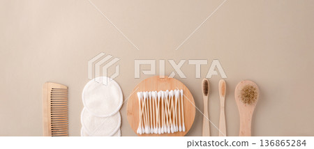 Eco-friendly bathroom essentials, bamboo toothbrushes, cotton swabs, reusable cotton pads, comb, facial brush. Green lifestyle, eco-consciousness Eco-friendly bathroom essentials, bamboo toothbrushes, cotton swabs, reusable cotton pads, comb, facial brush. Green lifestyle, eco-consciousness 136865284
