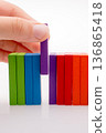 Hand holding color dominoes 136865418