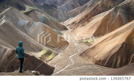 Woman on a lookout point enjoying views on the colorful rainbow mountain valley, Highlands, Iceland 136865767