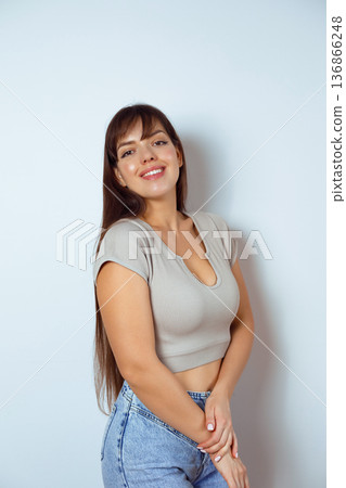 Confident woman posing isolated on neutral studio background Confident woman posing isolated on neutral studio background 136866248