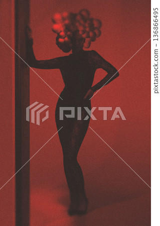 Woman silhouette wearing avant-garde headpiece in red light Woman silhouette wearing avant-garde headpiece in red light 136866495