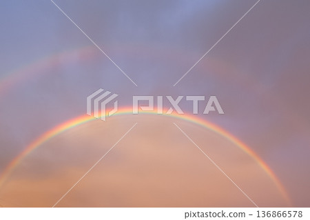 A lucky double rainbow in the evening sky A lucky double rainbow in the evening sky 136866578