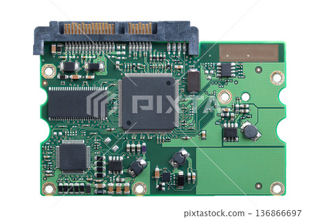 Printed circuit board, PCB of a hard disk drive, HDD, from above. Flat piece of layered fiberglass with copper traces, memory, and and support chips, to be mounted to the exterior of the device. Photo Printed circuit board, PCB of a hard disk drive, HDD, from above. Flat piece of layered fiberglass with copper traces, memory, and and support chips, to be mounted to the exterior of the device. Photo 136866697