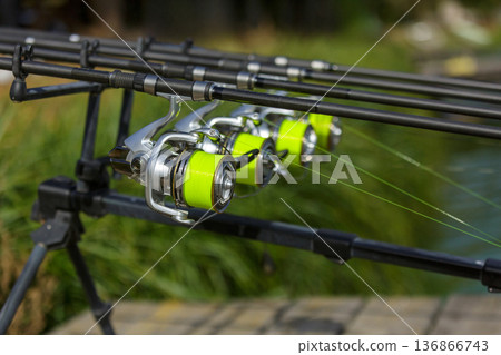 Fishing reels mounted on rod holder 136866743