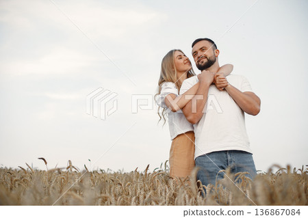 Cute couple in a field. Lady in a white blouse. Guy in a white shirt 136867084