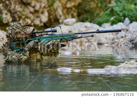 Camouflaged Sniper Soldier Aiming Precision Rifle While Wading Through Water in Tactical Gear Camouflaged Sniper Soldier Aiming Precision Rifle While Wading Through Water in Tactical Gear 136867118