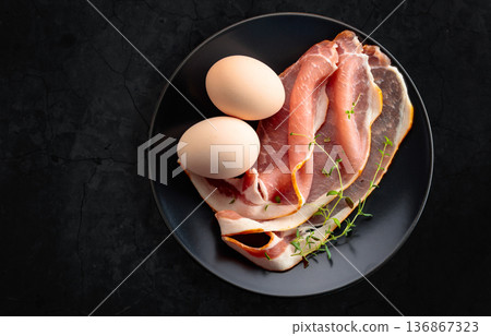 Pork bacon with thyme and eggs. Pork bacon with thyme and eggs. 136867323