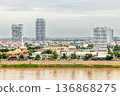 Modern apartment buildings rising above traditional houses along Tonle Sap riverbank in Phnom Penh, Cambodia 136868275