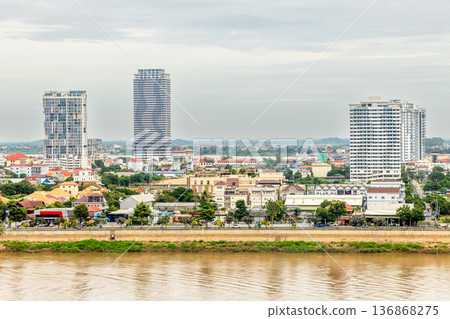 Modern apartment buildings rising above traditional houses along Tonle Sap riverbank in Phnom Penh, Cambodia 136868275