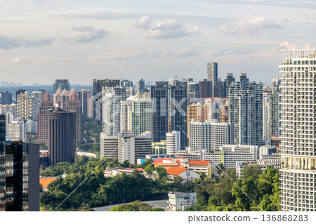 Modern business district skyline with steel and glass structures rising above the dense metropolitan landscape in the Republic of Singapore Modern business district skyline with steel and glass structures rising above the dense metropolitan landscape in the Republic of Singapore 136868283