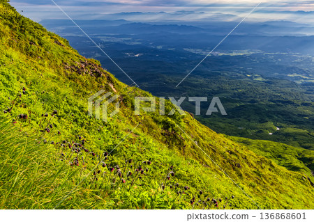 Morning view of Mt. Chokai and the mountain range illuminated by the morning sun from the outer rim of the volcano Morning view of Mt. Chokai and the mountain range illuminated by the morning sun from the outer rim of the volcano 136868601
