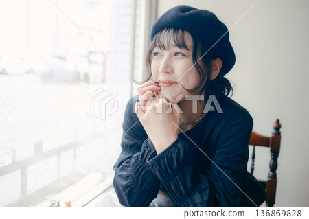 A Japanese woman in her 30s looking out the window at a cafe A Japanese woman in her 30s looking out the window at a cafe 136869828