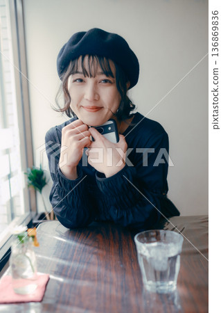 一位三十多歲的日本女性正望著窗外的咖啡館。 一位三十多歲的日本女性正望著窗外的咖啡館。 136869836