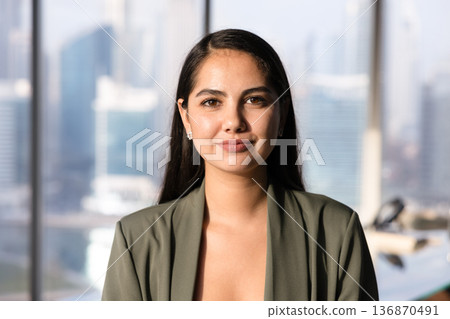 Positive beautiful Latin business leader woman posing for head shot 136870491