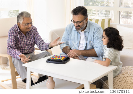 Multigenerational family playing together ball sort puzzle boardgame Multigenerational family playing together ball sort puzzle boardgame 136870511