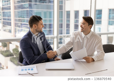 Two businessmen shaking hands in gesture of agreement Two businessmen shaking hands in gesture of agreement 136870540