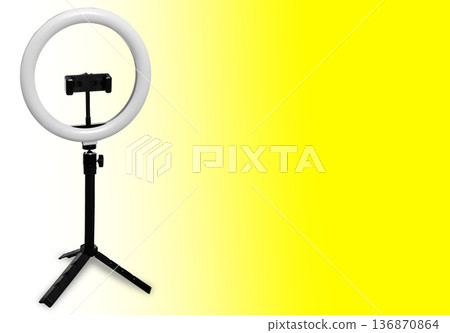 Selfie ring lamp with a tripod, on a white background and space for text on a yellow background Selfie ring lamp with a tripod, on a white background and space for text on a yellow background 136870864