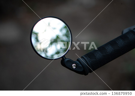 bicycle rear view mirror, attached to the handlebars of the bicycle bicycle rear view mirror, attached to the handlebars of the bicycle 136870950