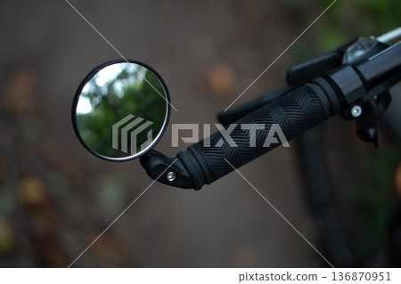 bicycle rear view mirror, attached to the handlebars of the bicycle bicycle rear view mirror, attached to the handlebars of the bicycle 136870951
