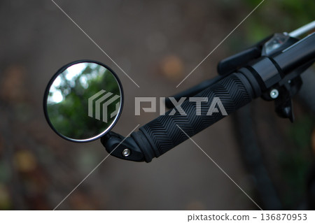 bicycle rear view mirror, attached to the handlebars of the bicycle bicycle rear view mirror, attached to the handlebars of the bicycle 136870953