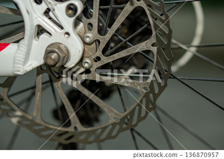 Rotor, brake disk on a bicycle wheel, close up Rotor, brake disk on a bicycle wheel, close up 136870957
