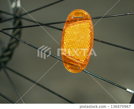 a reflector attached to a bicycle wheel. a reflector attached to a bicycle wheel. 136870967