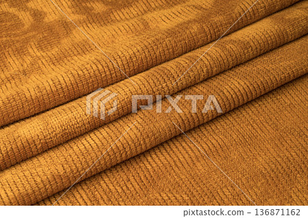 Orange fabric with three pleats in the middle Orange fabric with three pleats in the middle 136871162