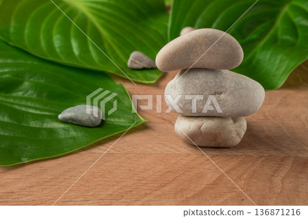Green Leaves, Wayward Hosts and Stones of Various Velecheny on the Background of a Wooden Board Green Leaves, Wayward Hosts and Stones of Various Velecheny on the Background of a Wooden Board 136871216
