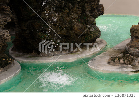 Waterfall, water drop into an artificial reservoir against the background of stones, natural origin Waterfall, water drop into an artificial reservoir against the background of stones, natural origin 136871325