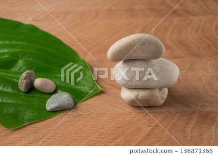 Green Leaves, Wayward Hosts and Stones of Various Velecheny on the Background of a Wooden Board Green Leaves, Wayward Hosts and Stones of Various Velecheny on the Background of a Wooden Board 136871366