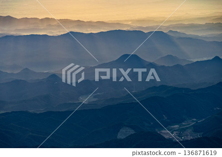 Mountain ranges bathed in the morning sun as seen from Mount Chokai and the Seven High Mountains Mountain ranges bathed in the morning sun as seen from Mount Chokai and the Seven High Mountains 136871619