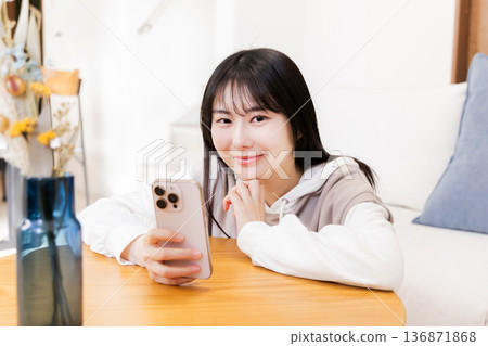 A woman watching a smartphone A woman watching a smartphone 136871868