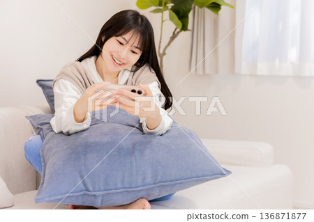 Young woman looking at a smartphone 136871877