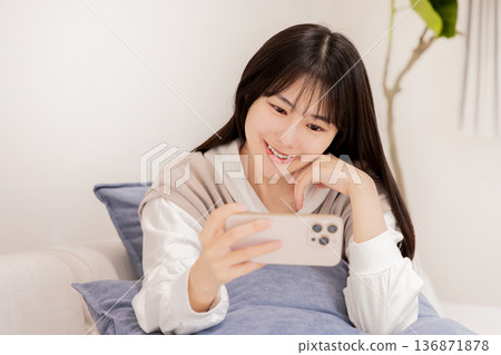 A woman watching a smartphone 136871878
