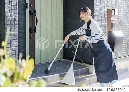 Women cleaning the garden, cleaning the entrance 136872041