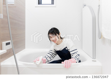 Housewife cleaning the bathroom 136872047