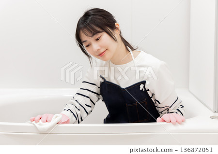 Housewife cleaning the bathroom 136872051
