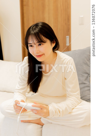 Young woman playing online games Young woman playing online games 136872076