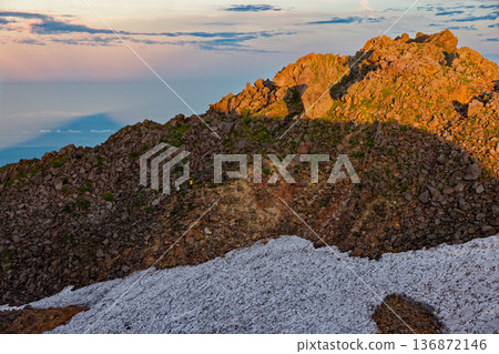 View of Mount Chokai and the Seven High Mountains, with the morning sun shining on the summit of Shinzan and its shadow reflected in the Sea of Japan. View of Mount Chokai and the Seven High Mountains, with the morning sun shining on the summit of Shinzan and its shadow reflected in the Sea of Japan. 136872146