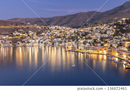 Symi Island Harbor At Sunset With Pastel Houses Greece Symi Island Harbor At Sunset With Pastel Houses Greece 136872461